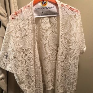 Lacy wrap and fringed edges at the bottom.